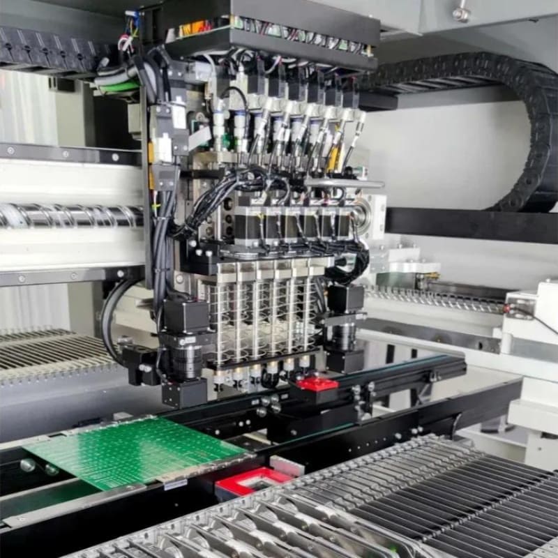 Automated SMT pick-and-place machine placing components onto a PCB with feeder reels – Fuxin PCBA